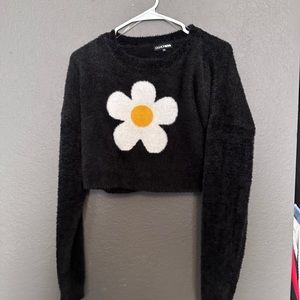 Black fuzzy cropped sweater with daisy print